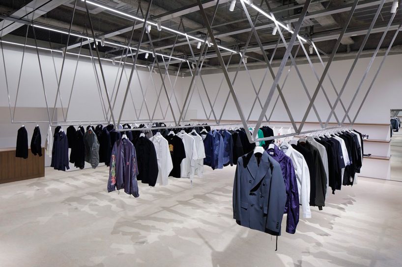 CASE-REAL suspends clothes on V-shaped metal racks at the côte à côte boutique