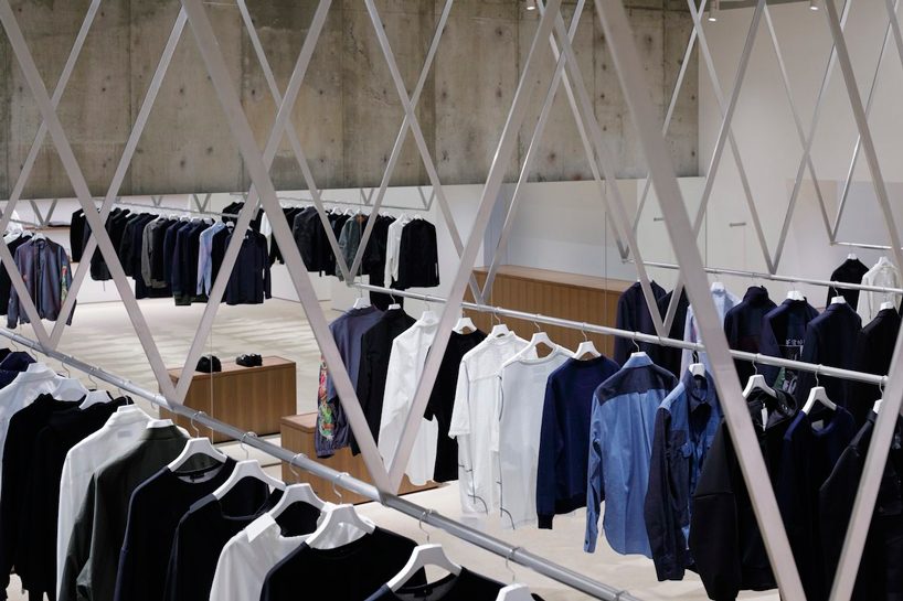 CASE-REAL suspends clothes on V-shaped metal racks at the côte à côte boutique