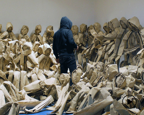 claudio acuña j. folds paper into people to reflect our use of public spaces