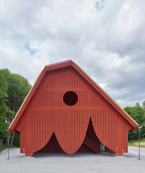 sandellsandberg clads swedish wildlife park building in playful red wooden drapes