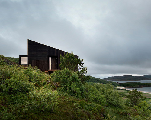 kappland arkitekter places cabin on steep, seaside slope in norwegian island