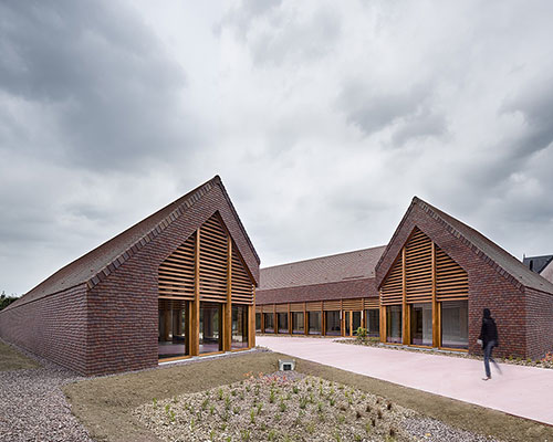 lemoal lemoal architectes wrap exposed wooden structure in continuous tile in normandy