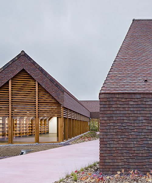 lemoal lemoal architectes wrap exposed wooden structure in continuous tile in normandy
