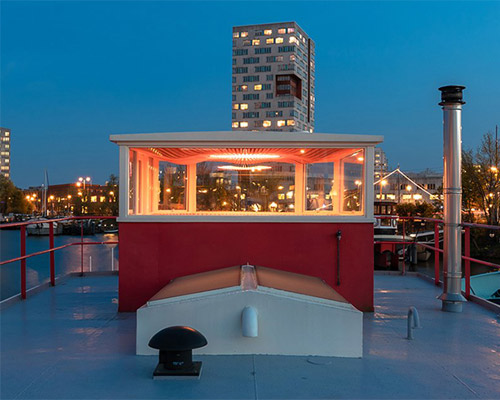 mass design materializes a wave in wood for lighthouse atop amsterdam boat