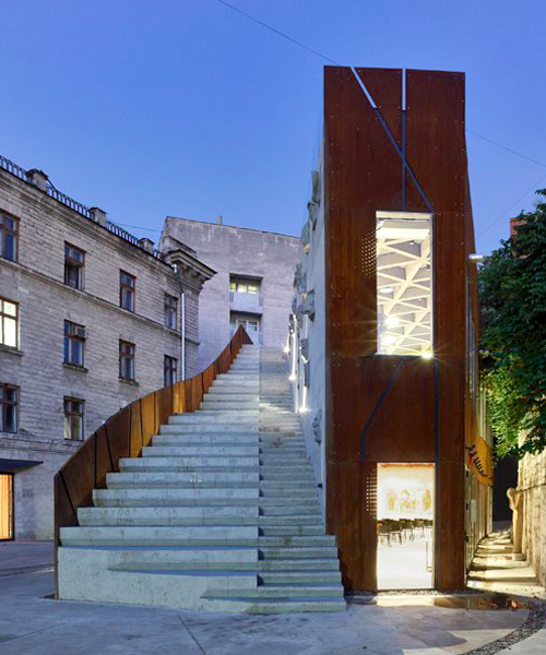 maxim calujac wraps corten steel and an external staircase around an arts center in moldova