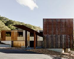 the zero-net energy miner road residence is wrapped in a rainscreen of corten steel
