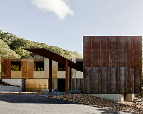 the zero-net energy miner road residence is wrapped in a rainscreen of corten steel