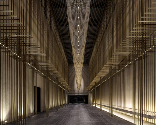 the oval partnership installs 8000 bronze flutes inside a theater in china