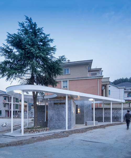 shulin architectural design unites individual blocks under curved roof for public toilet in china