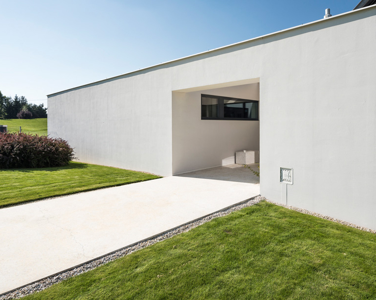 toprojekt's polish residence doubles as a barrier that blocks highway noise