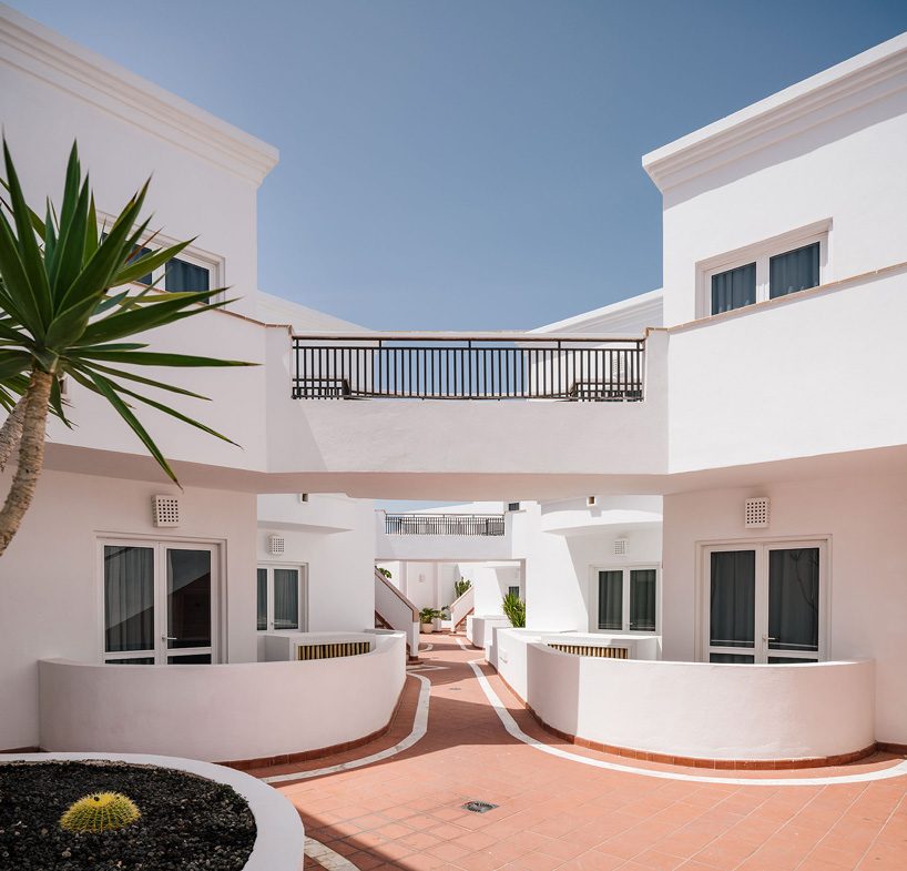 zooco estudio's flamingo club hotel in tenerife combines bamboo, basalt stone + white hues