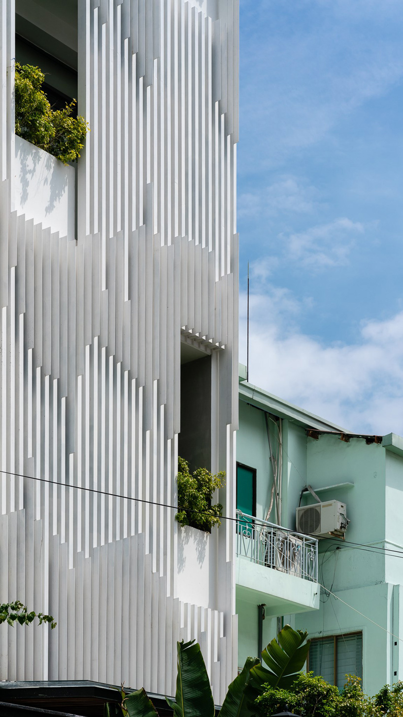 AD9 architects clads vietnamese office building in dynamic façade and greenery