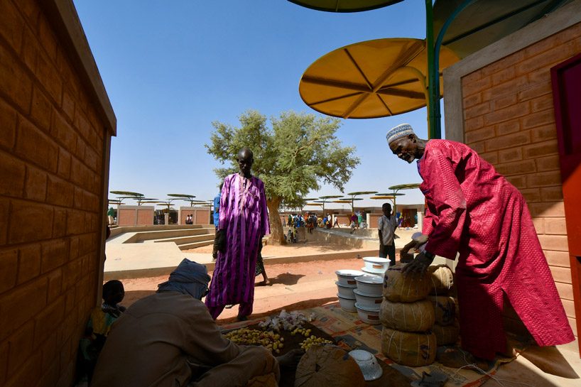 atelier masōmī uses colorful metal canopies to build dandaji market in niger
