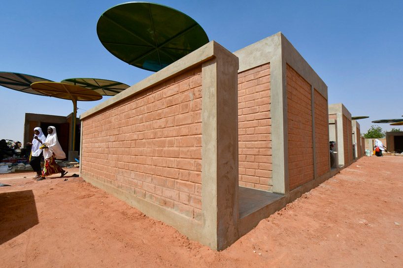 atelier masōmī uses colorful metal canopies to build dandaji market in niger