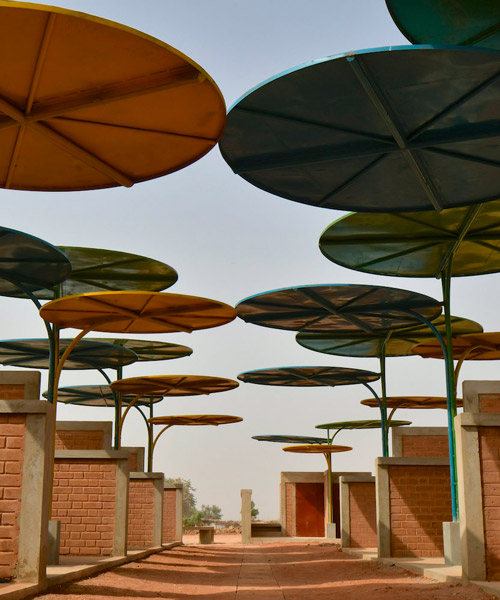 atelier masōmī uses colorful metal canopies to build dandaji market in niger