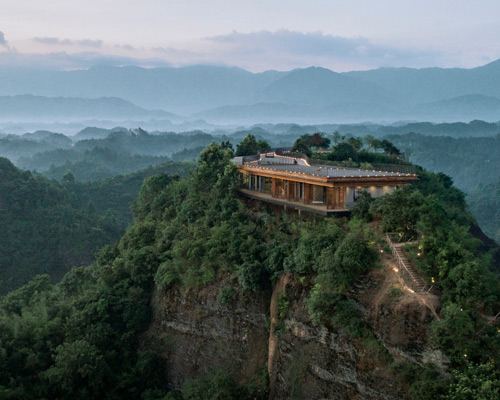 mountaintop hotel in china offers views across a landscape of rivers, forests, and hills