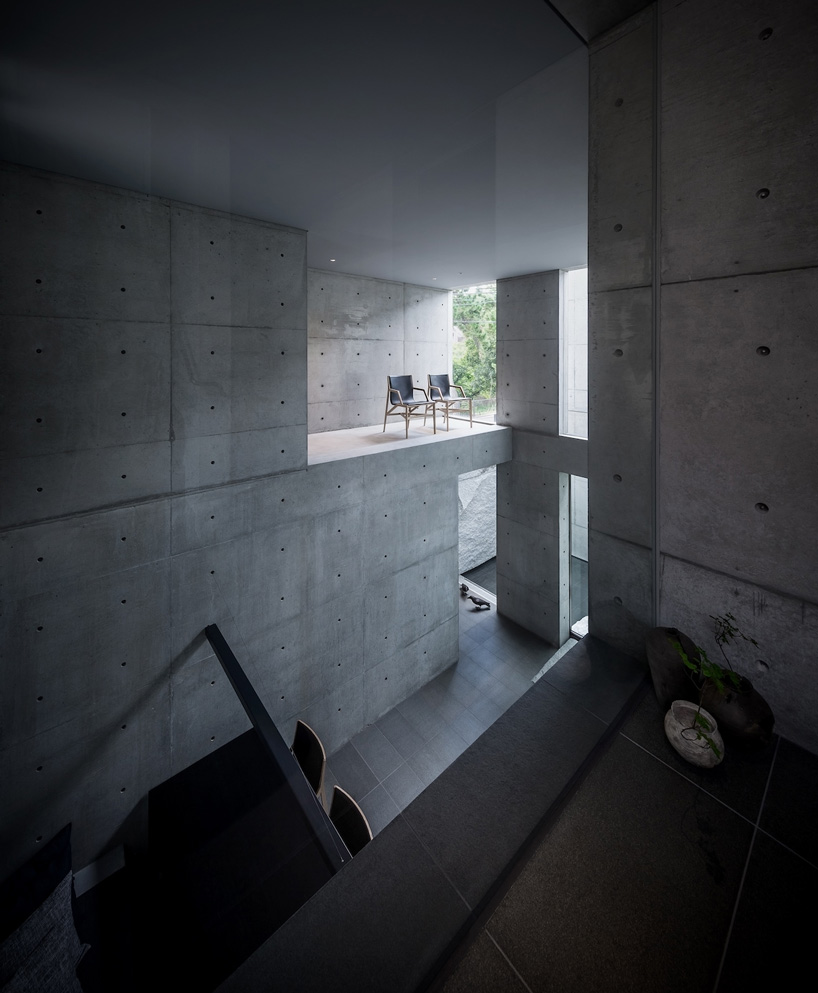 gosize builds concrete residence on top of a natural stone base in japan