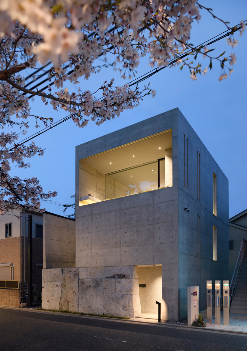 gosize builds concrete residence on top of a natural stone base in japan