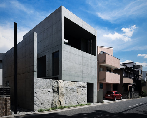 gosize builds concrete residence on top of a natural stone base in japan