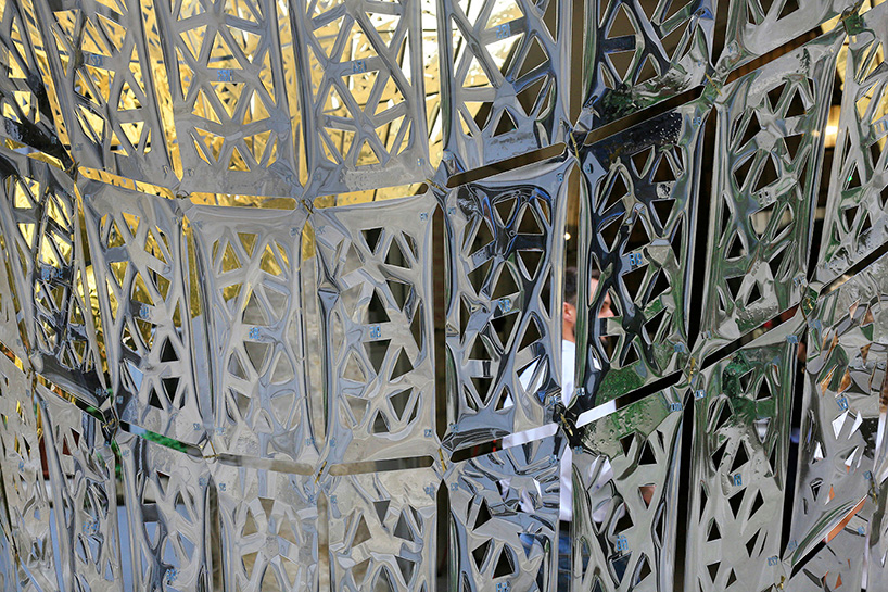 designers suspend parametric golden butterfly within a historic courtyard in montpellier