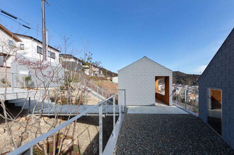 geo-graphic design lab stacks huts on a slope for family residence 