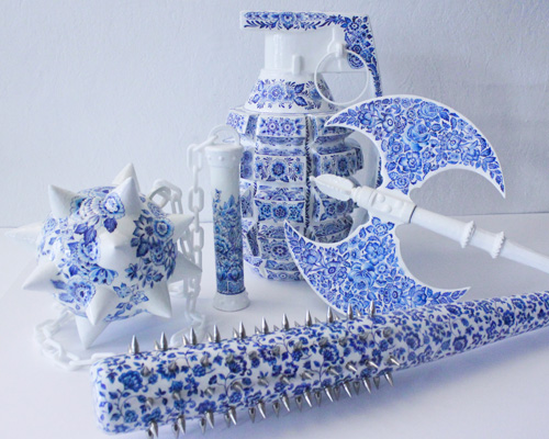 helena hauss hand paints ceramic weapons in delft blue style to champion female fierceness