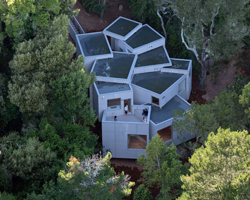 the mill valley house cascades down the side of a steep hill in california