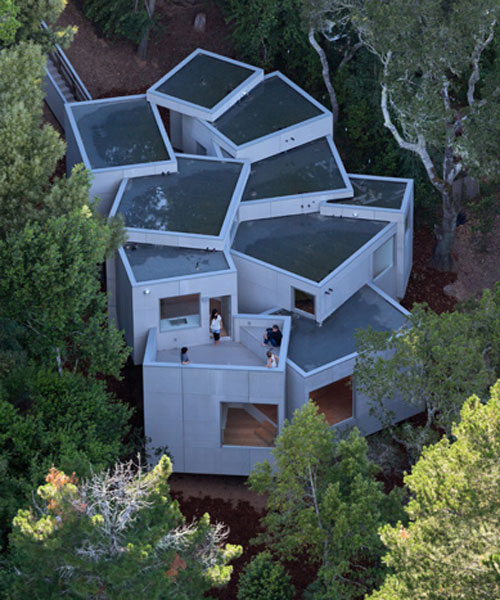 the mill valley house cascades down the side of a steep hill in california