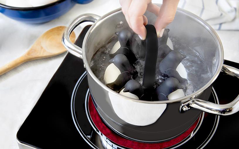 penguin-shaped egg-holder and boiler designed to dive into hot water