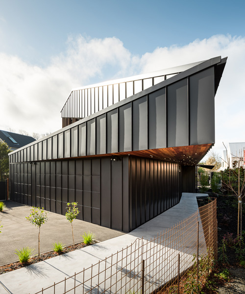 first light studio wraps the shark house in angular steel planes + timber in new zealand