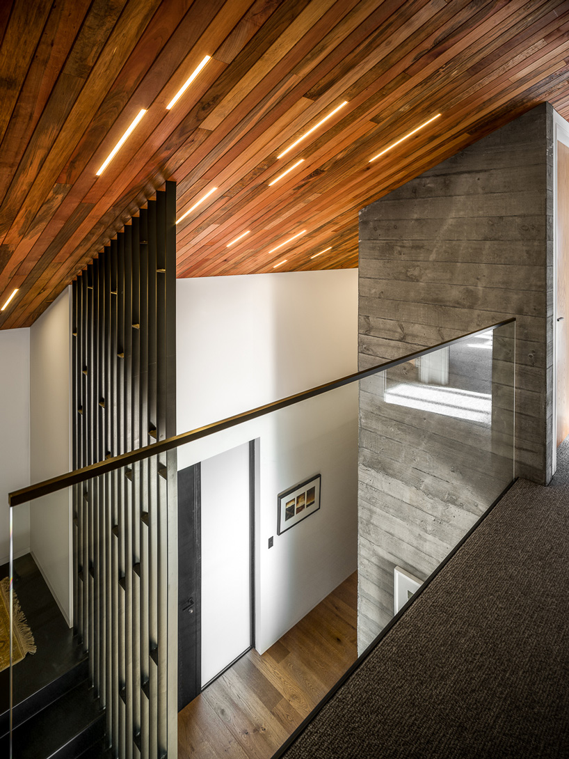 first light studio wraps the shark house in angular steel planes + timber in new zealand