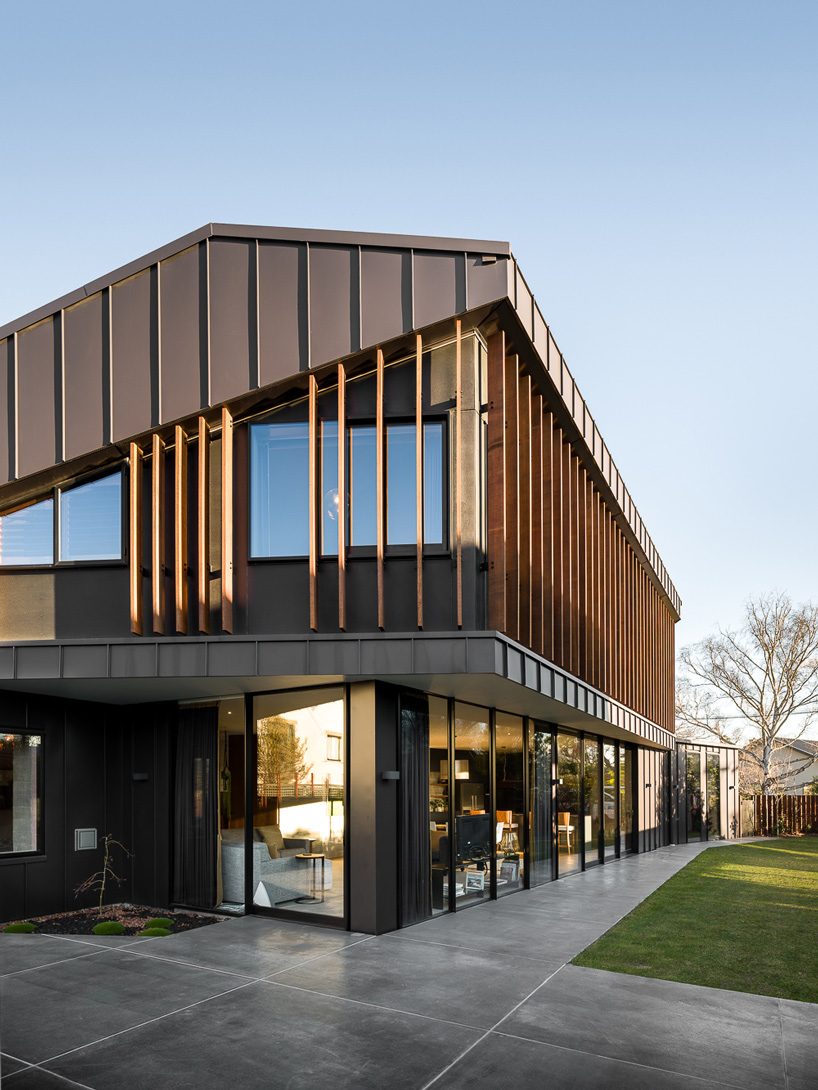 first light studio wraps the shark house in angular steel planes + timber in new zealand