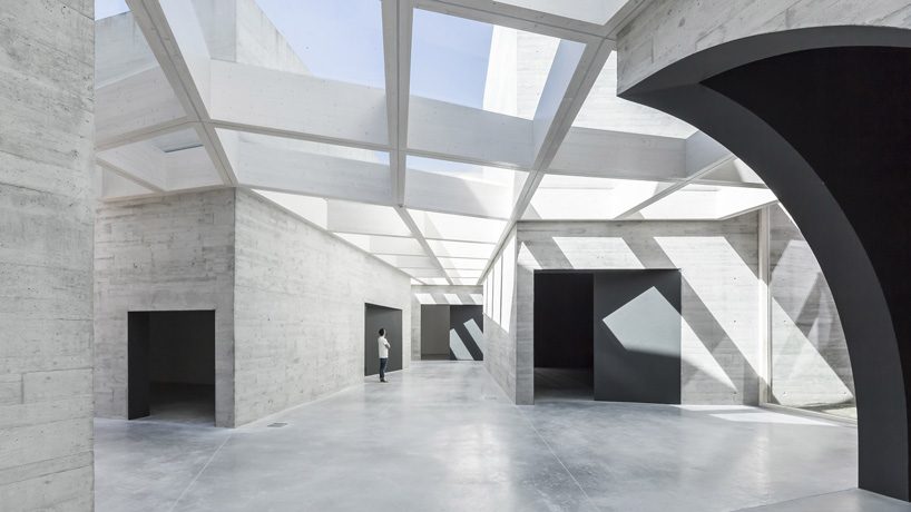 spaceworkers joins varying concrete volumes for romanesque exhibition building in portugal