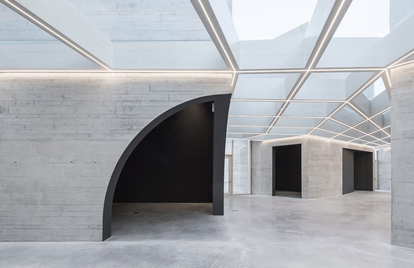 spaceworkers joins varying concrete volumes for romanesque exhibition building in portugal