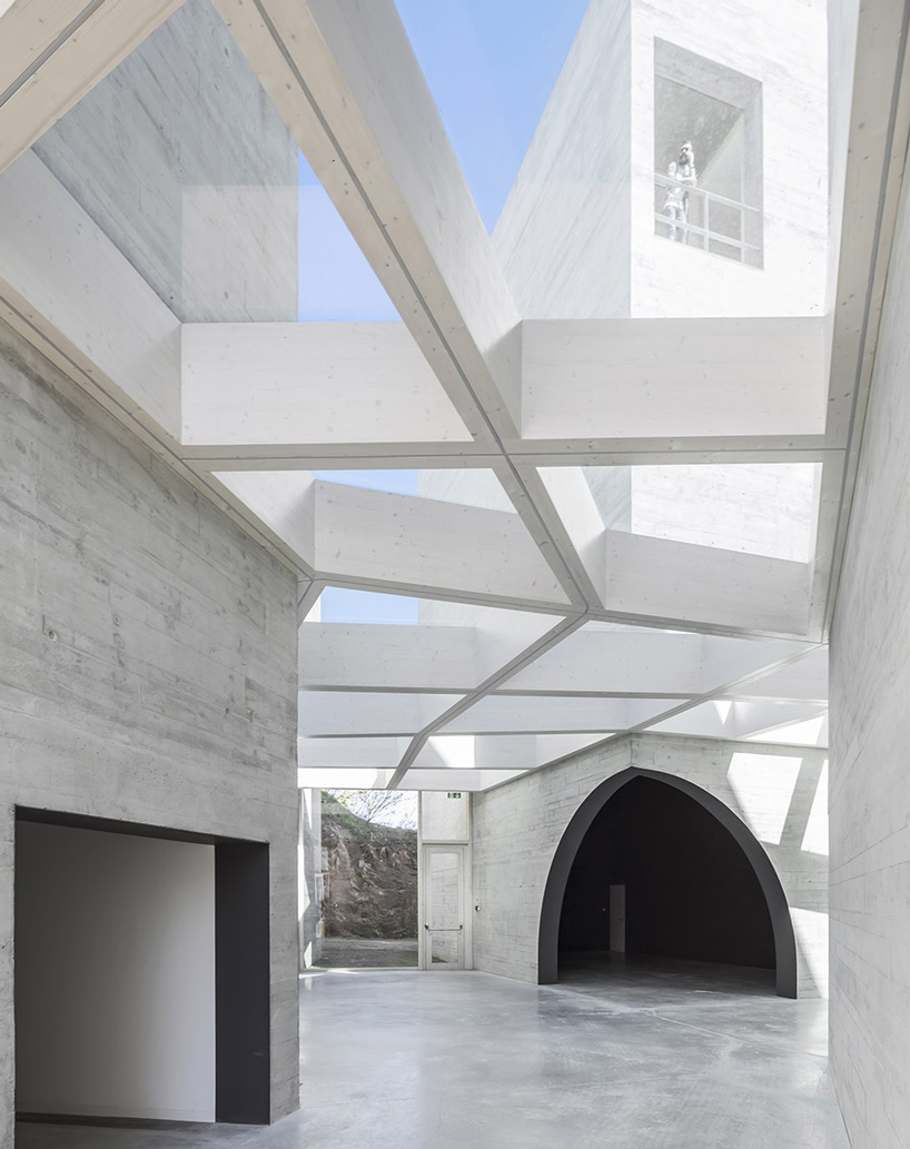 spaceworkers joins varying concrete volumes for romanesque exhibition building in portugal