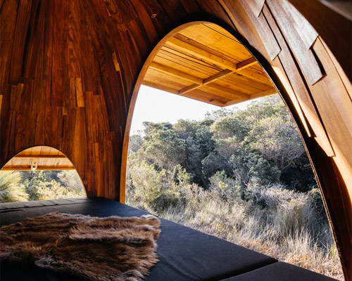 half-dome timber camp dwellings scattered along tasmania's wukalina walk