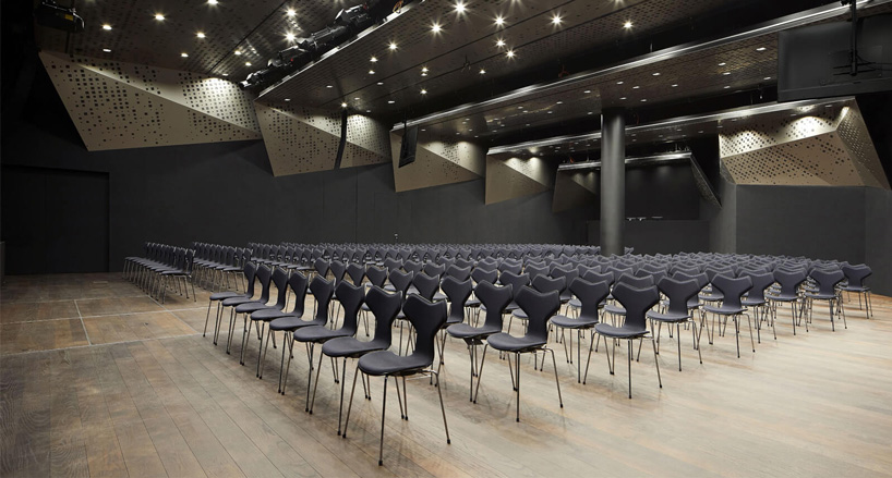 x architekten envelops KTM motohall in a sweeping dynamic facade in austria