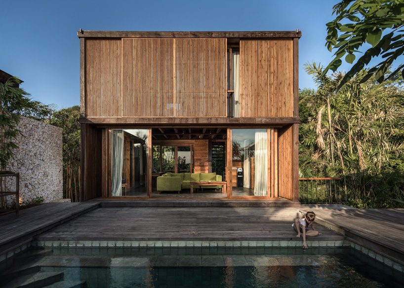 alexis dornier builds house in bali with timber + façade of movable screens