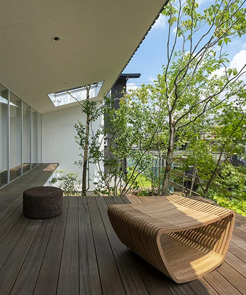 arbol design wraps a riverside house in metal cladding in kawachinagano, japan