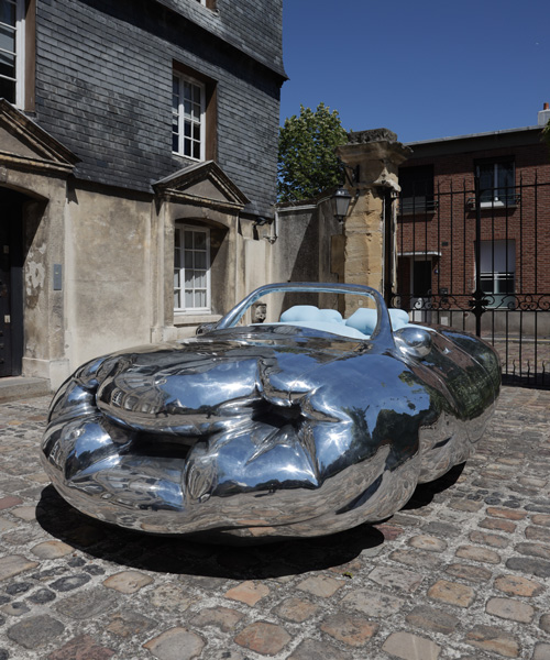erwin wurm parks his fat car, narrow house, and big coat across the french city of le havre