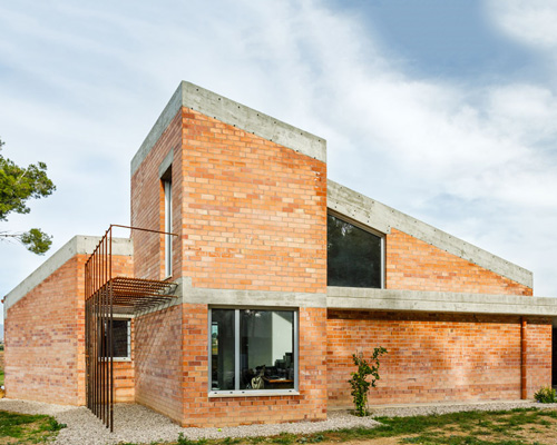 jesús perales builds casa almudena as an asymmetrical brick residence in spain