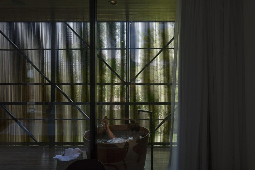 jobim carlevaro arquitetos finishes hotel suite in brazil with movable façade of wooden slats