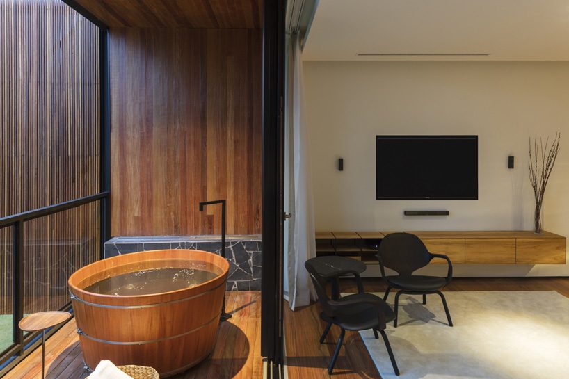 jobim carlevaro arquitetos finishes hotel suite in brazil with movable façade of wooden slats