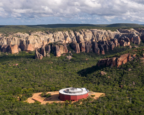 the spiral-shaped 'museu da natureza' is set amid brazil's natural landscape