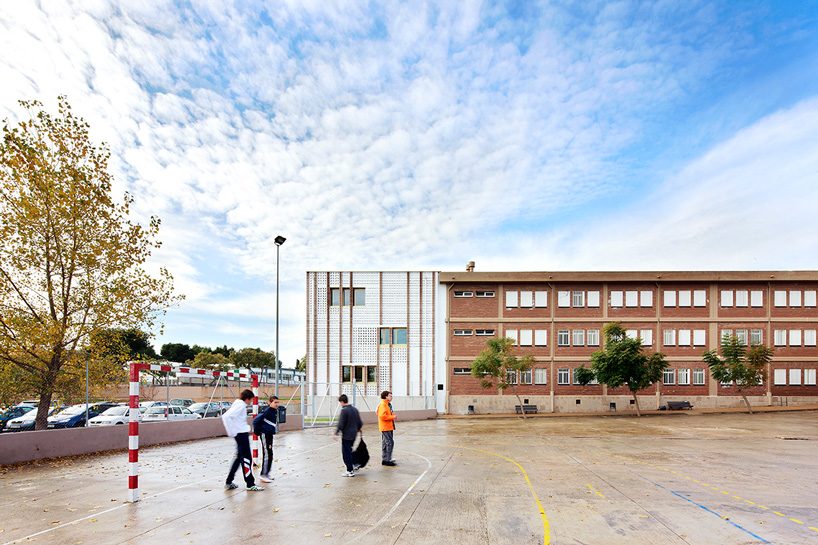 SMS arquitectos wraps high school extension with patterned façade in mallorca