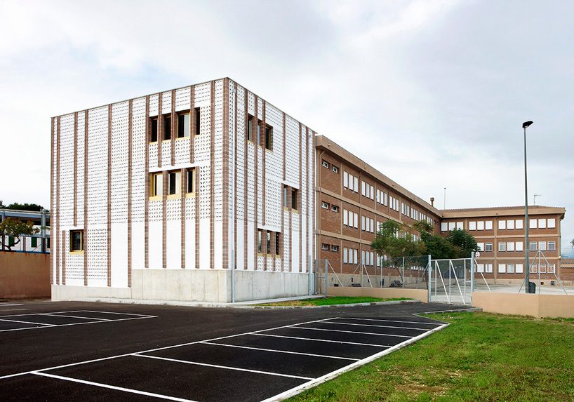 SMS arquitectos wraps high school extension with patterned façade in mallorca