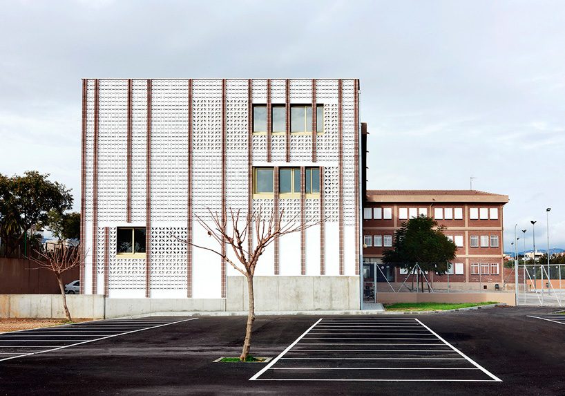 SMS arquitectos wraps high school extension with patterned façade in mallorca