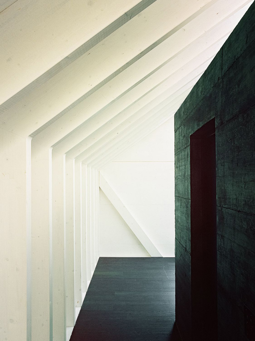 stocker lee architteti clads office building in switzerland in rust-red tiles + bricks