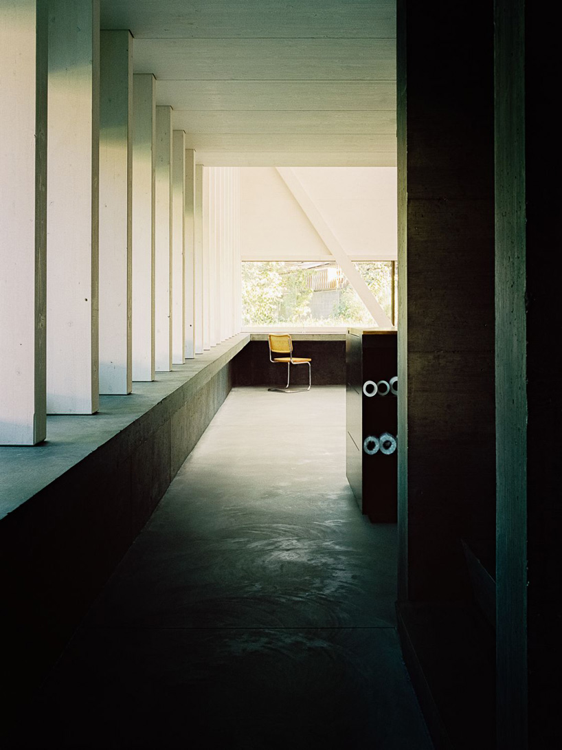 stocker lee architteti clads office building in switzerland in rust-red tiles + bricks