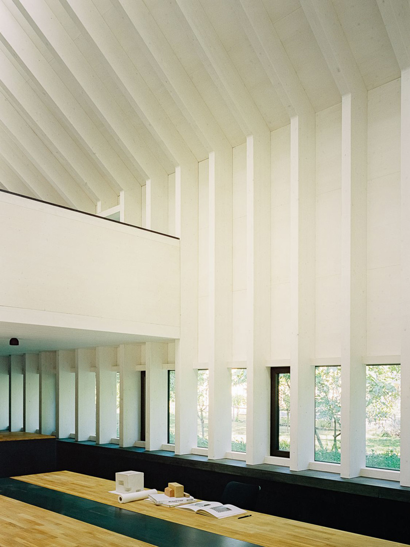 stocker lee architteti clads office building in switzerland in rust-red tiles + bricks